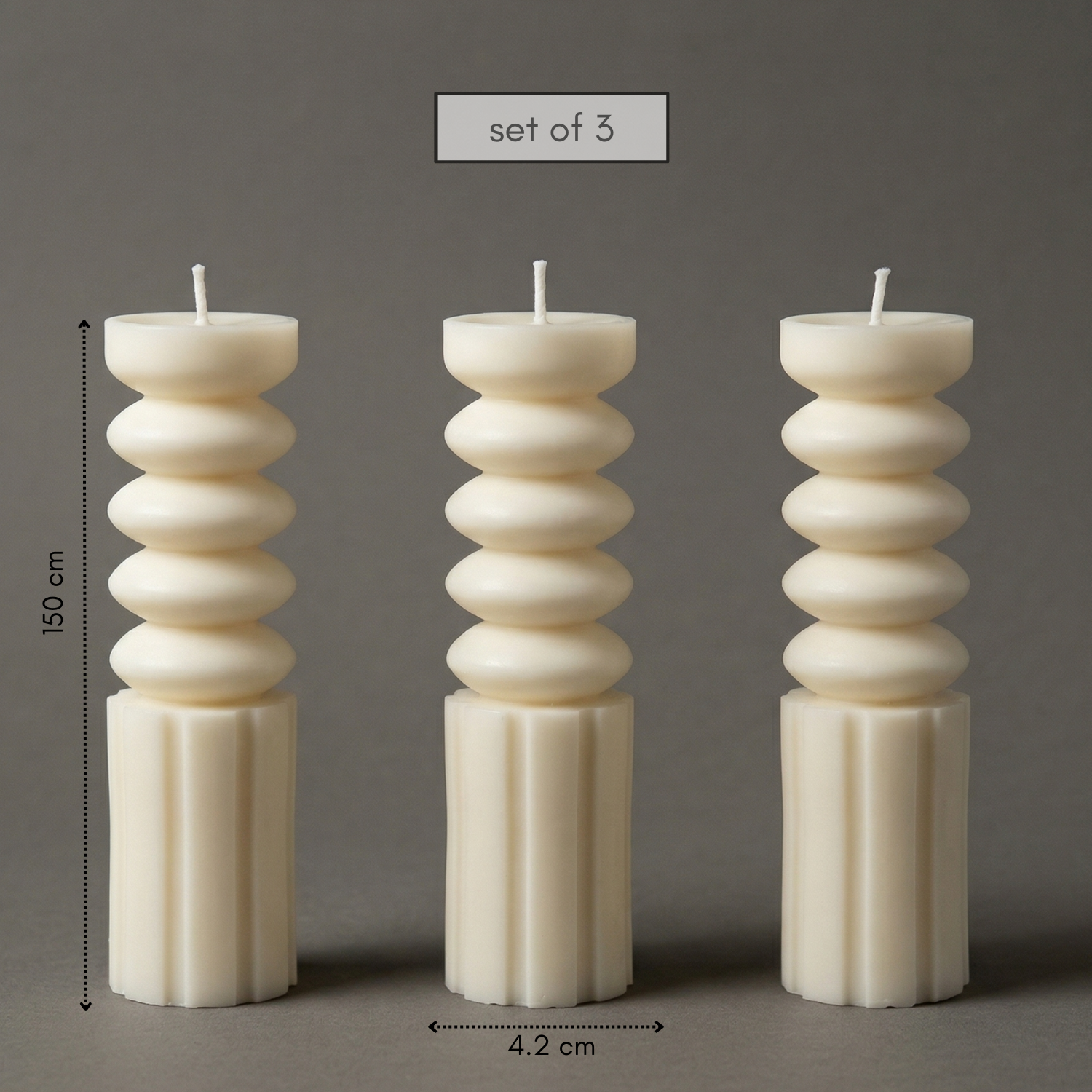 Set of three decorative candles with stacked design on a gray background