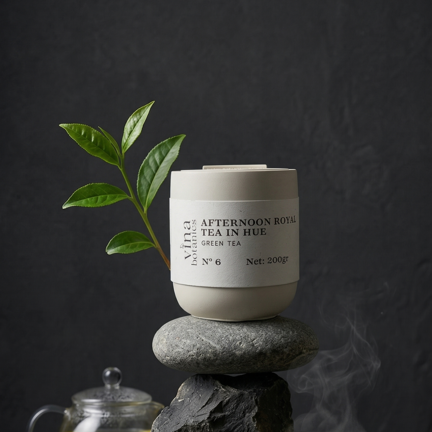Tea canister with a leaf on a stone against a dark background