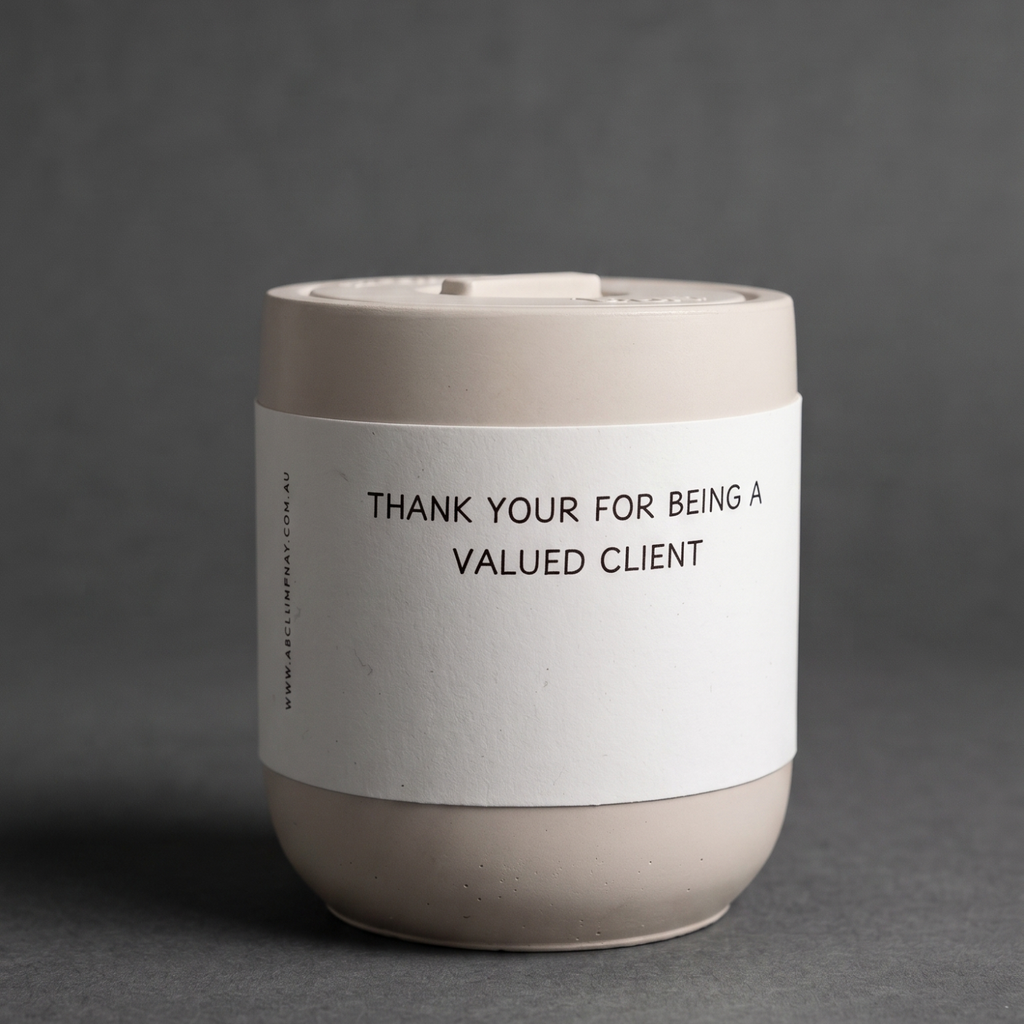 Ceramic cup with a label on a gray background