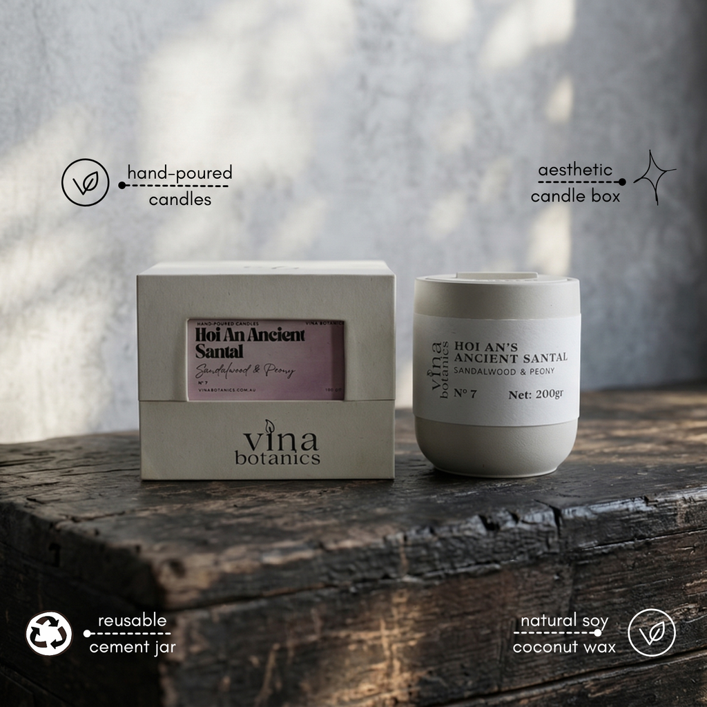 Vina Botanics candle and packaging on a wooden surface with a blurred background