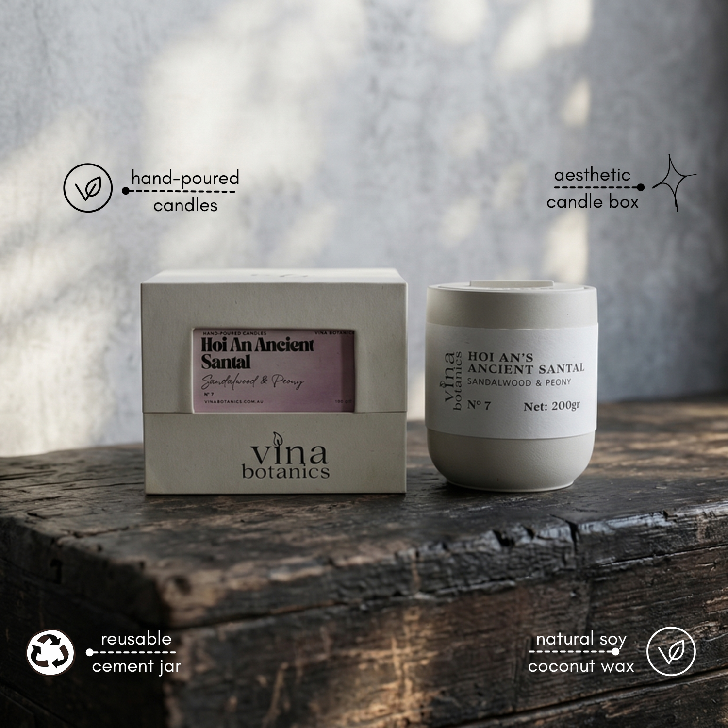 Vina Botanics candle and packaging on a wooden surface with a blurred background