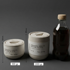 Two containers labeled 'Mekong Delta River Guava' with measurements and a bottle on a dark background.