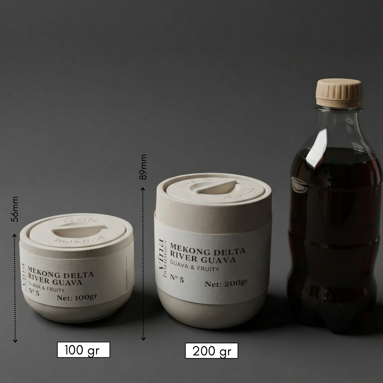 Two containers labeled 'Mekong Delta River Guava' with measurements and a bottle on a dark background.