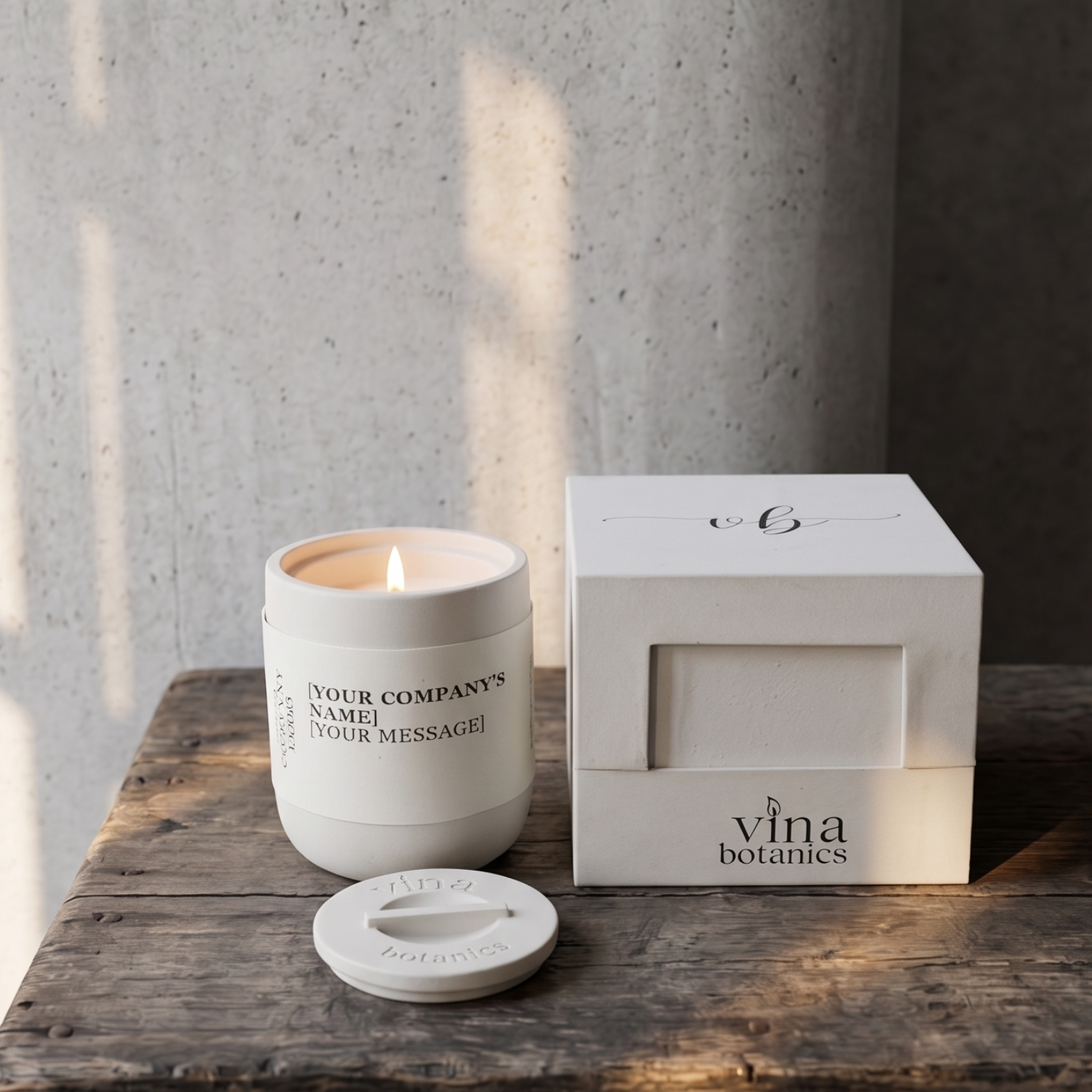 White candle with branded lid and packaging on a wooden surface